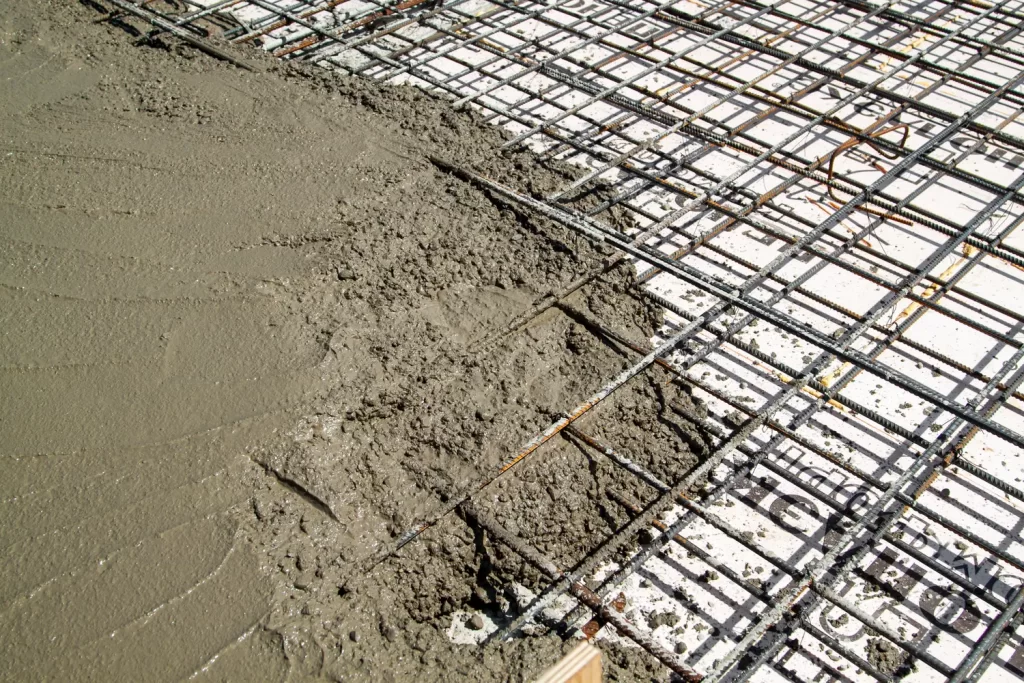 picture of wire mesh on a construction site with cement beginning to be filled in